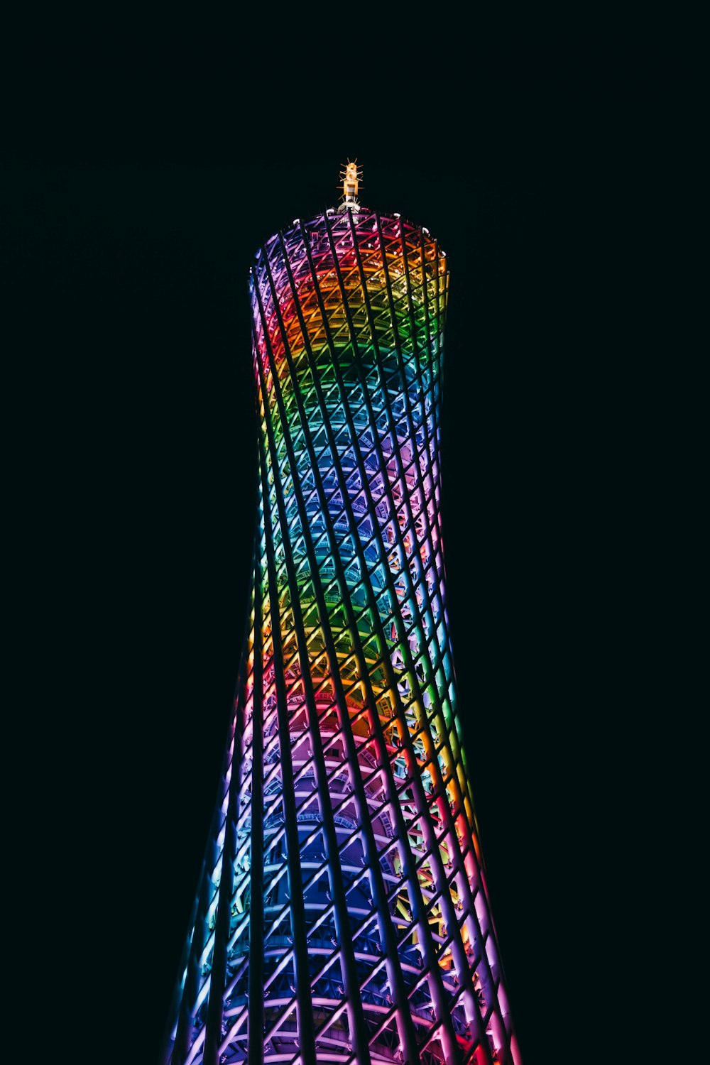 a very tall building with a rainbow colored roof