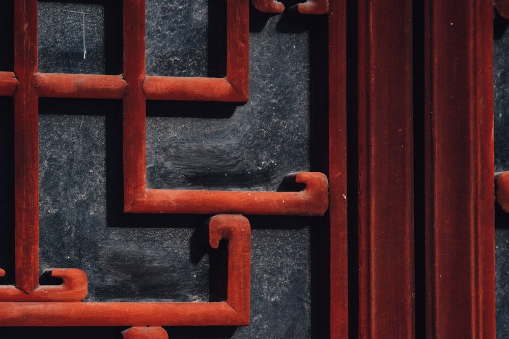 a close up of a metal door with red handles