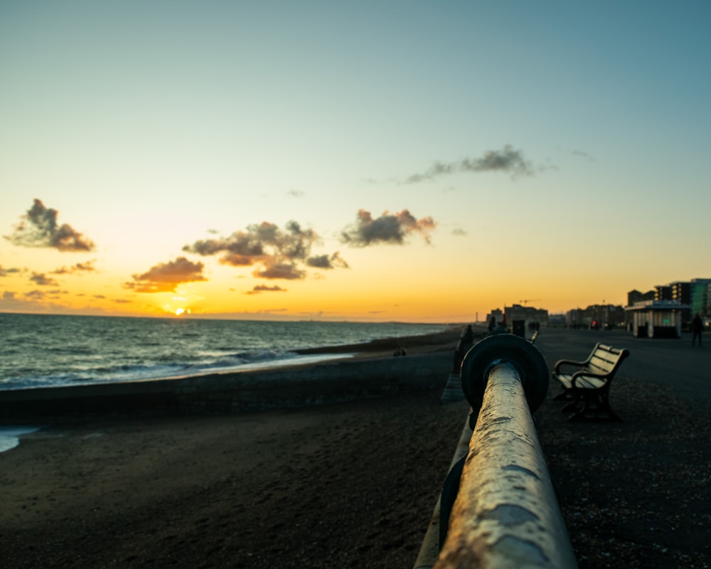 people, bench, and buildings on shore during day