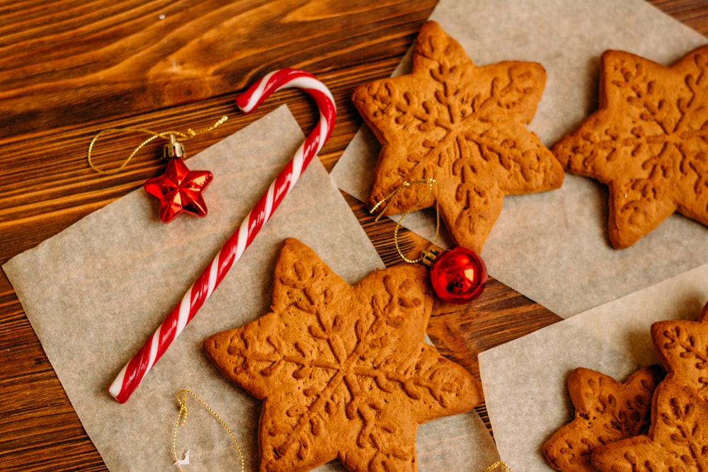 candy cane and cookies on wooden surface