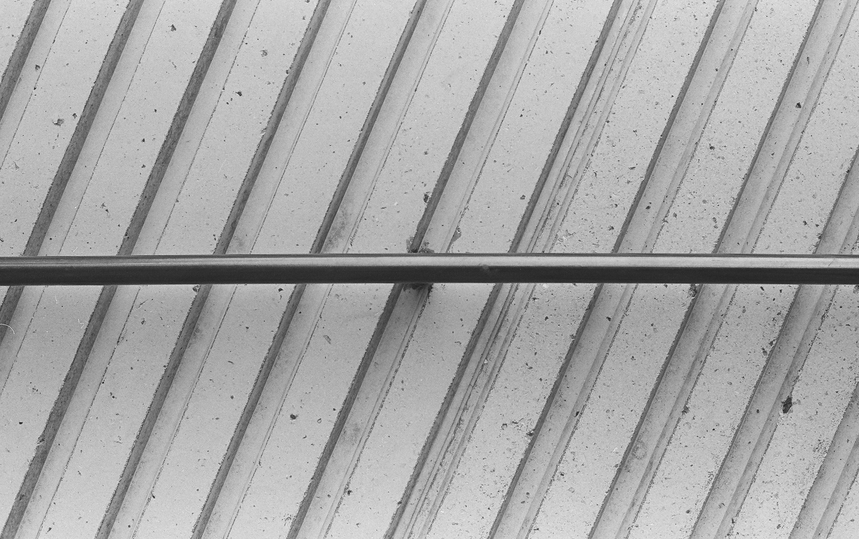 gray metal bar on white surface