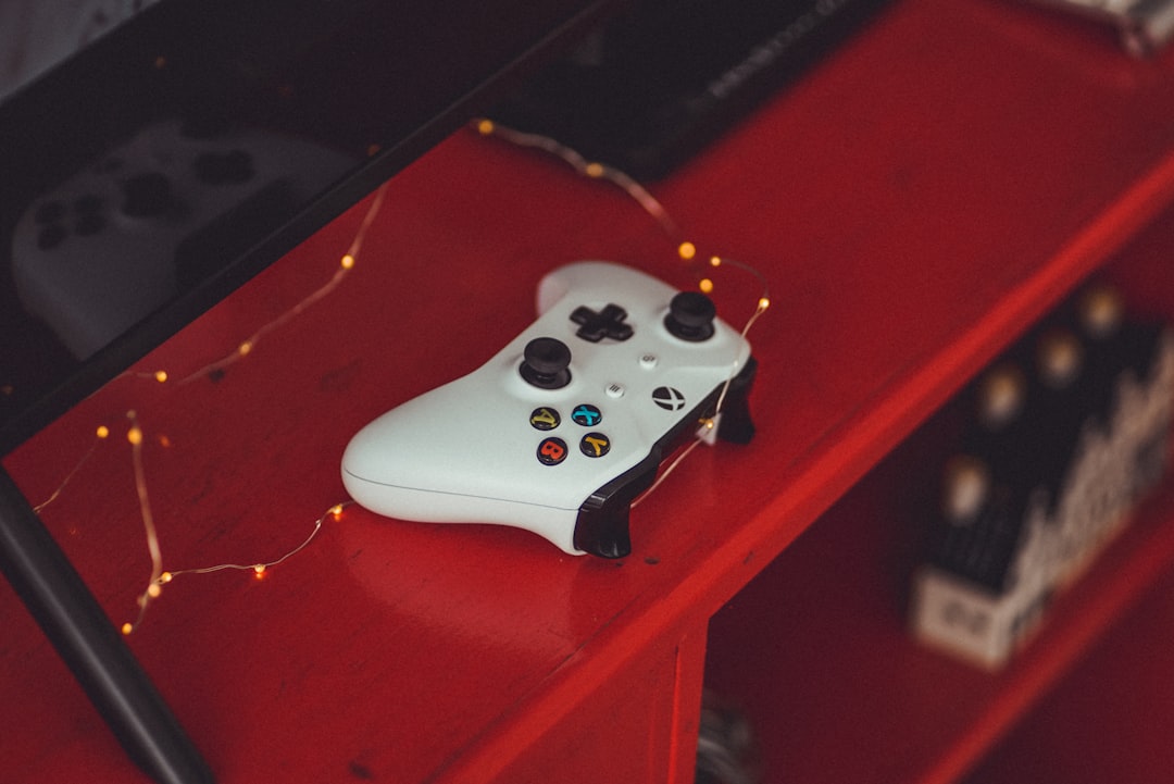 shallow focus photo of white Microsoft Xbox One wireless game controller