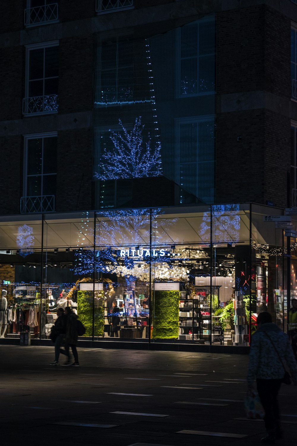 people walking near building during night time