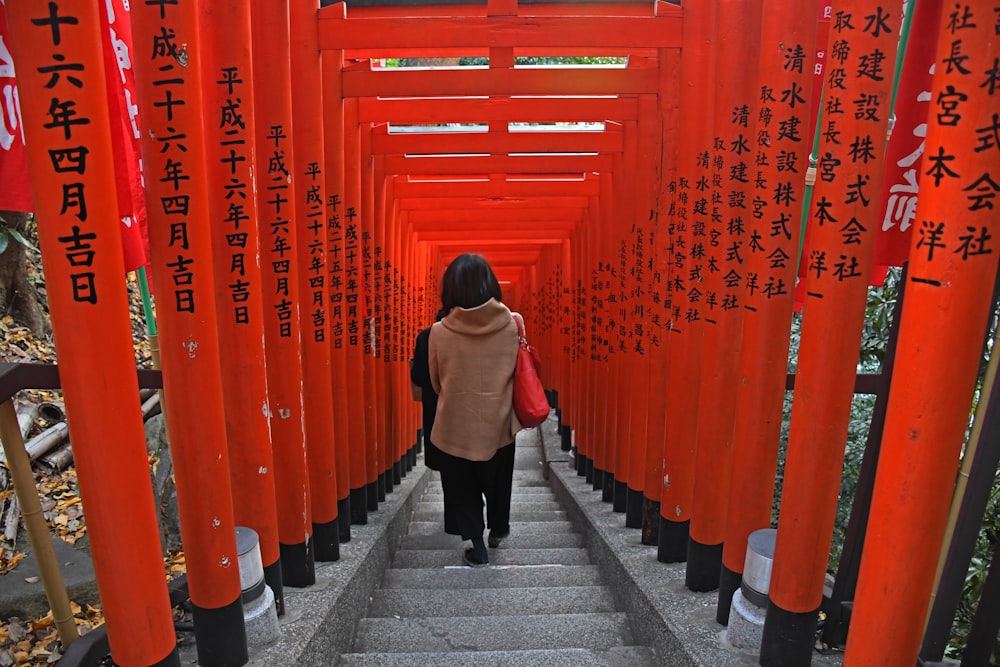 people walking on concrete stairs in Shinto shrine