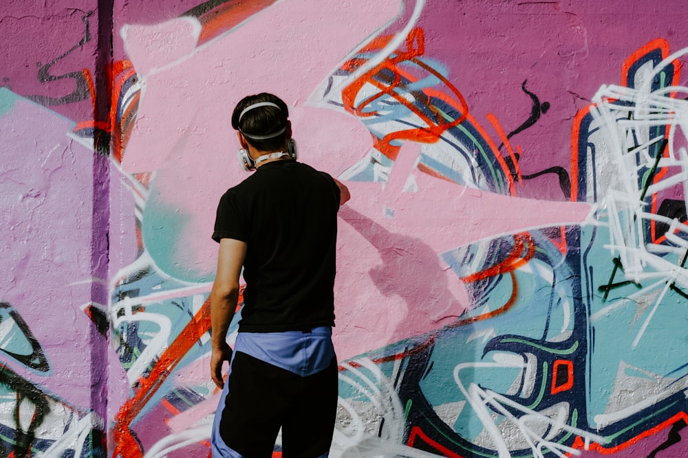 man painting on wall