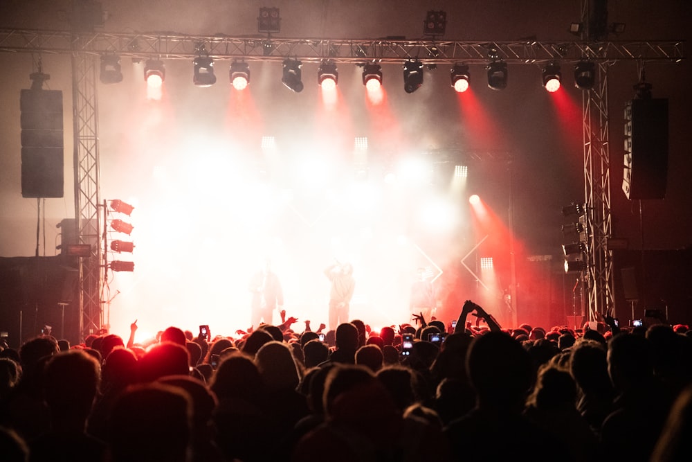 people performing on stage beside people