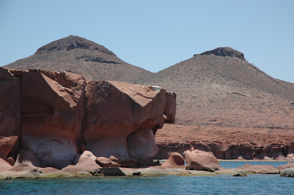 cliff near body of water during daytime