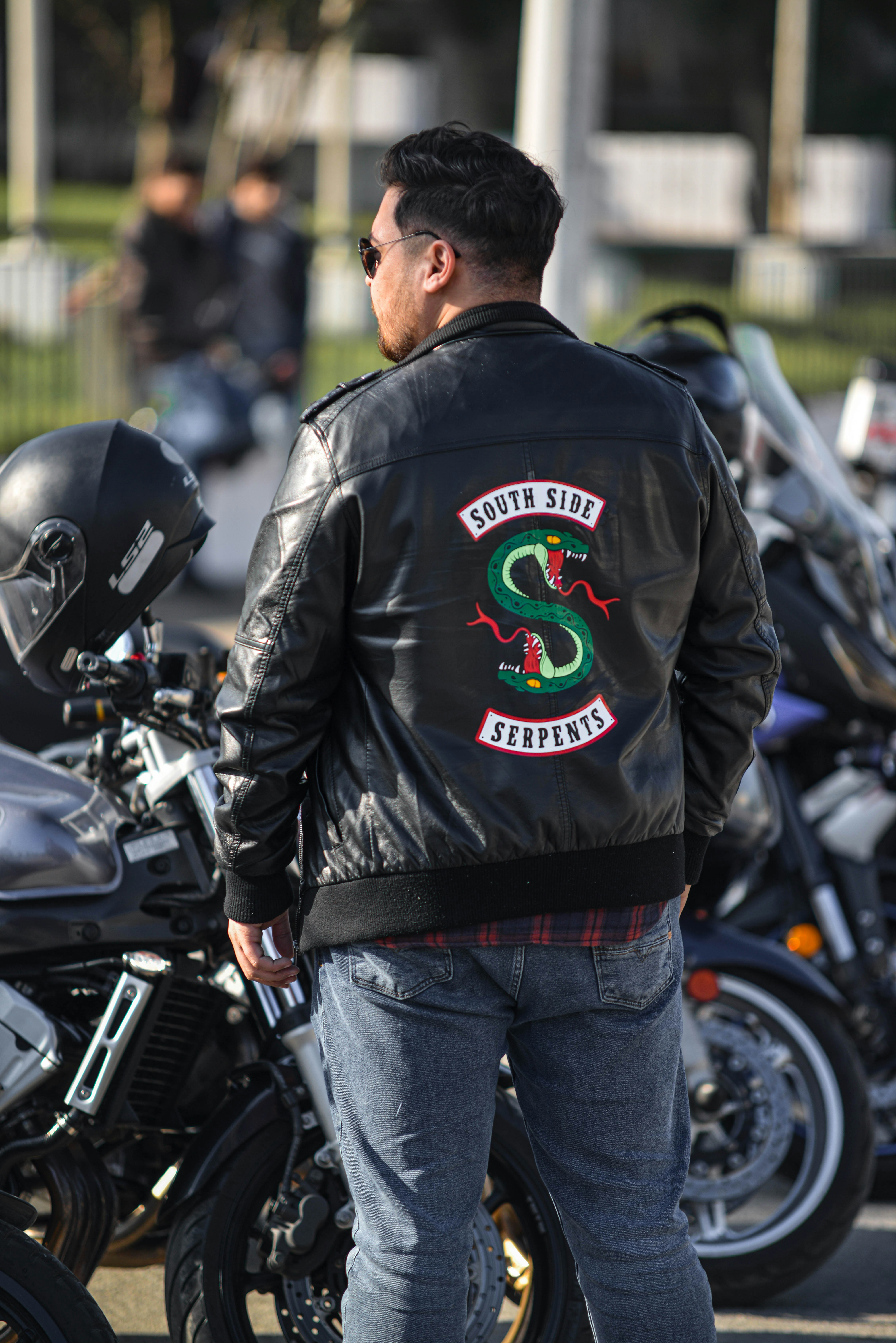 man standing beside a motorcycle