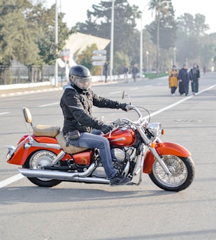 man riding motorcycle on road near people during day