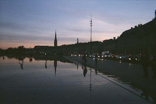 people in street during nighttime in Place de la Bourse France