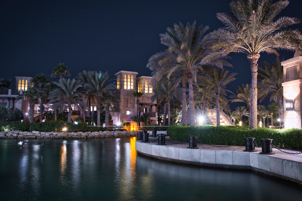 landscape photography of a hotel with swimming pool during nighttime