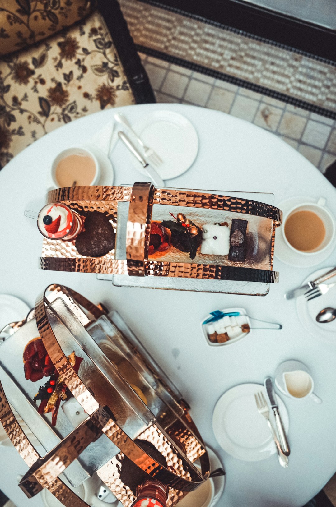 food photography of varieties of baked cakes and white ceramic saucers