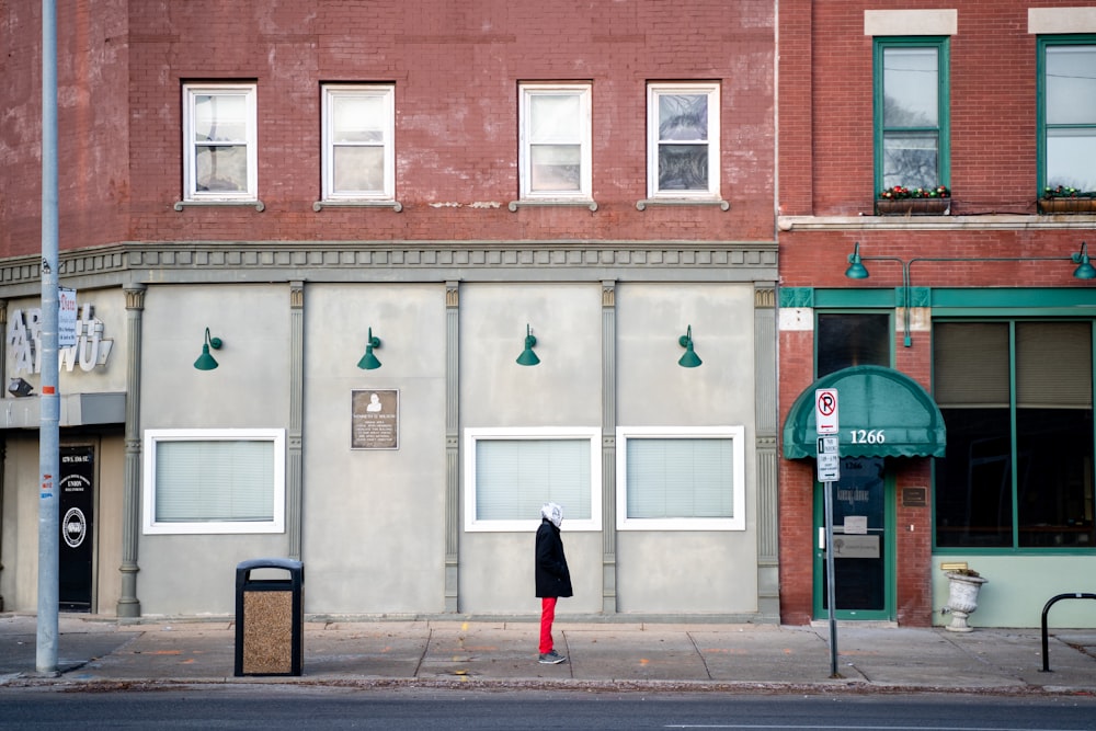 person standing on sidewalk during daytime