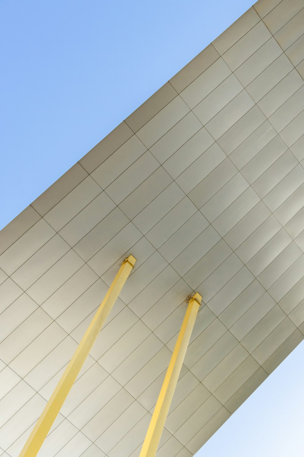 low-angle photography of white building structure under blue sky