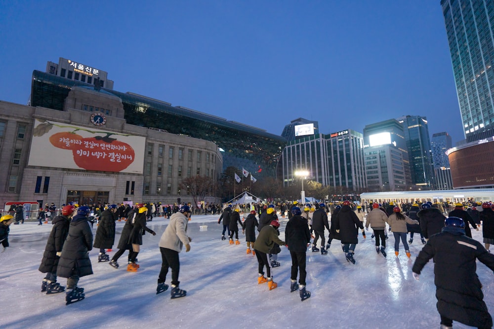 people doing skating on snowfield