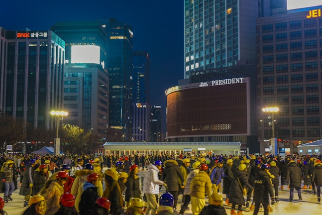 A vibrant synthetic ice rink set up in a bustling London corporate lobby, surrounded by engaged guests