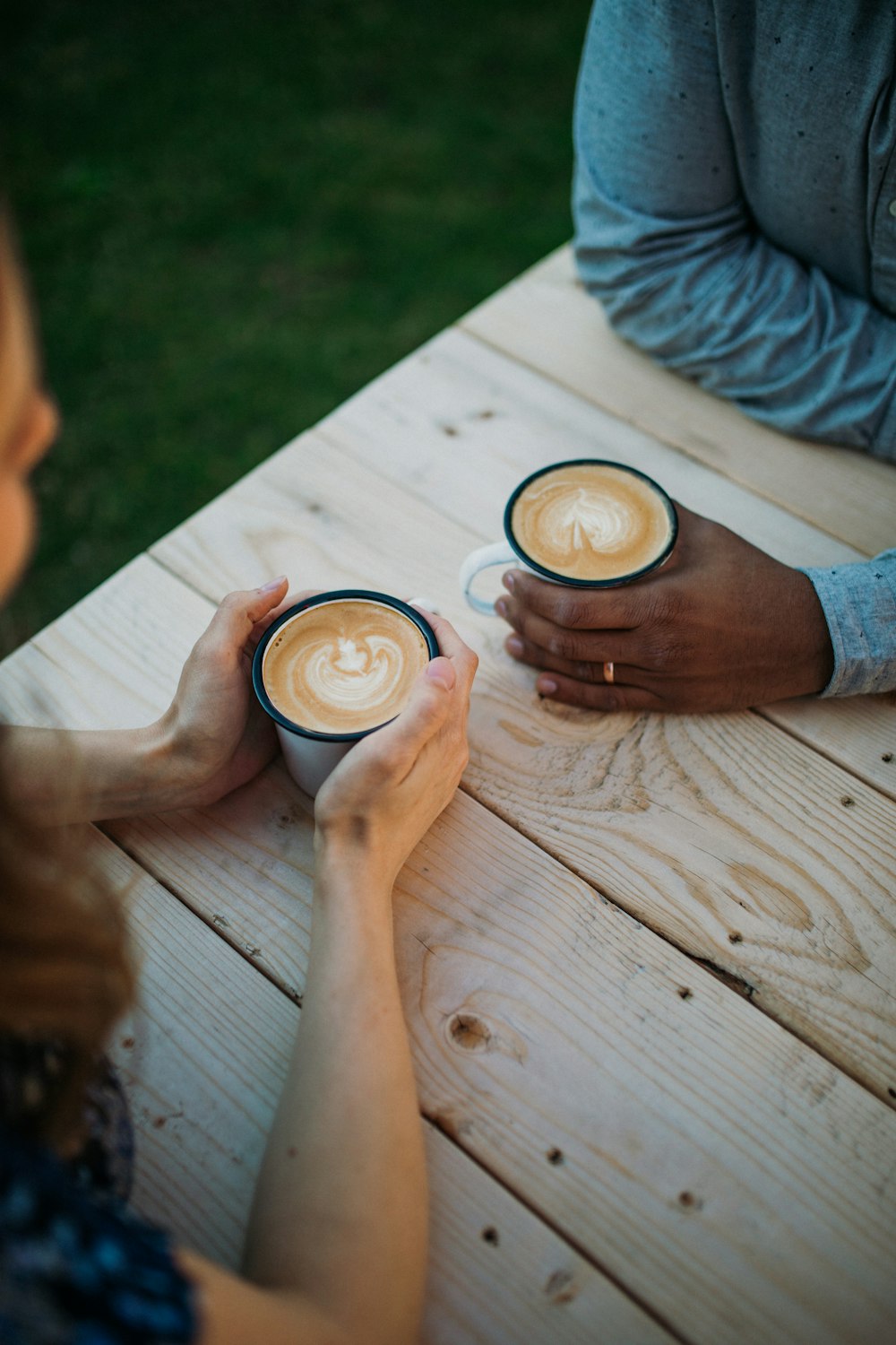 selective focus photography of man and woman sitting in front of each other