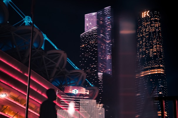 silhouette of man beside building at night
