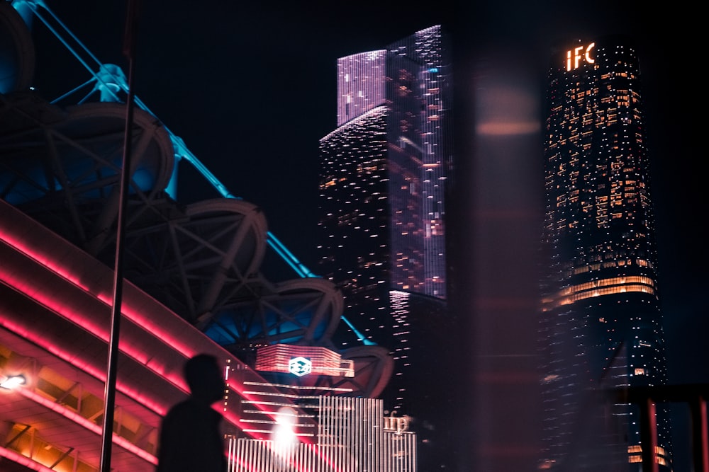 silhouette of man beside building at night