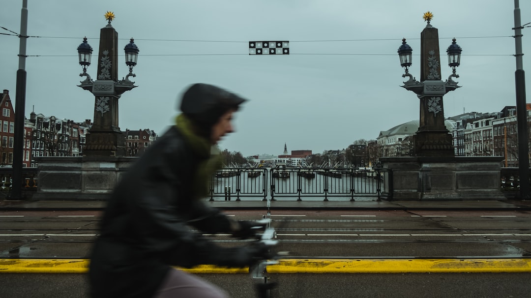 person cycling on road during daytime