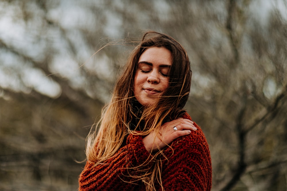 selective focus photography of woman wearing brown sweater