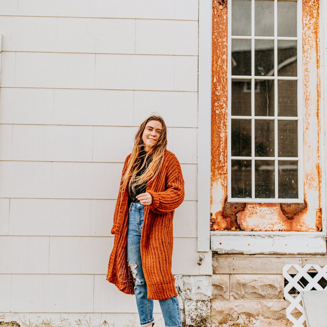 woman wearing long brown coat