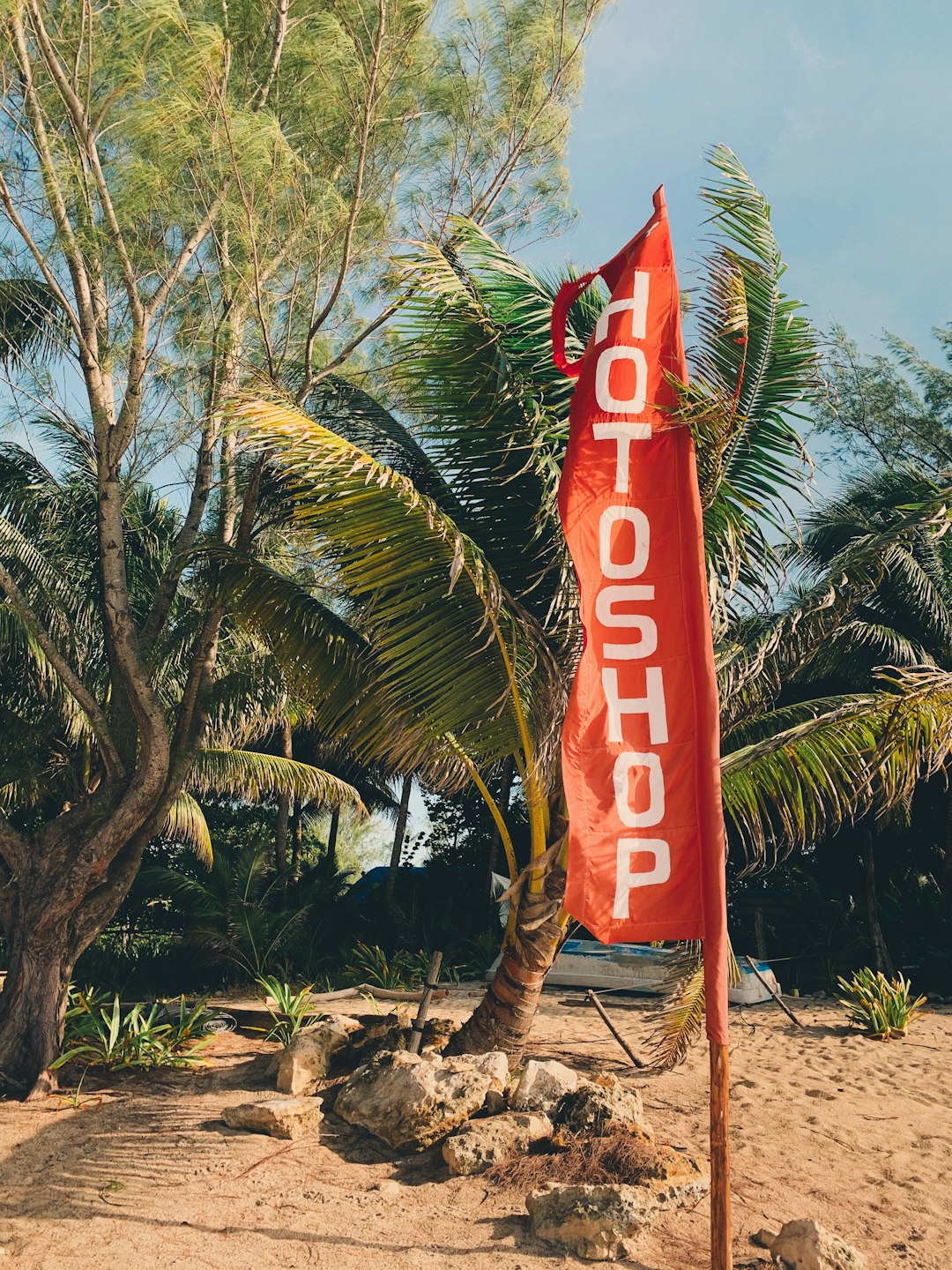 Hot Shop banner surrounded with green trees on beach