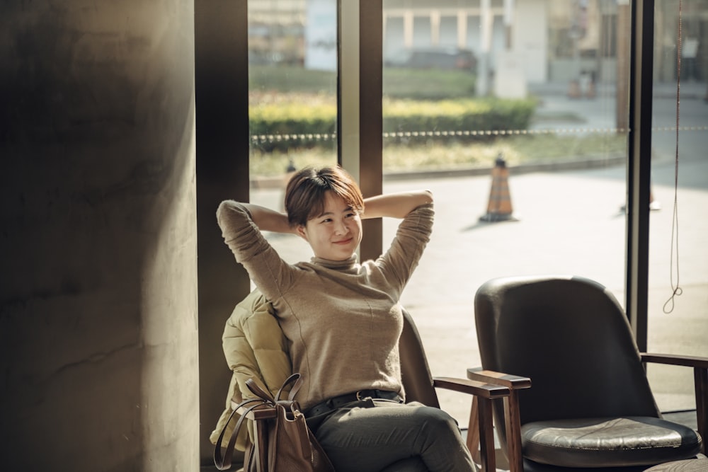 woman smiling and sitting inside room