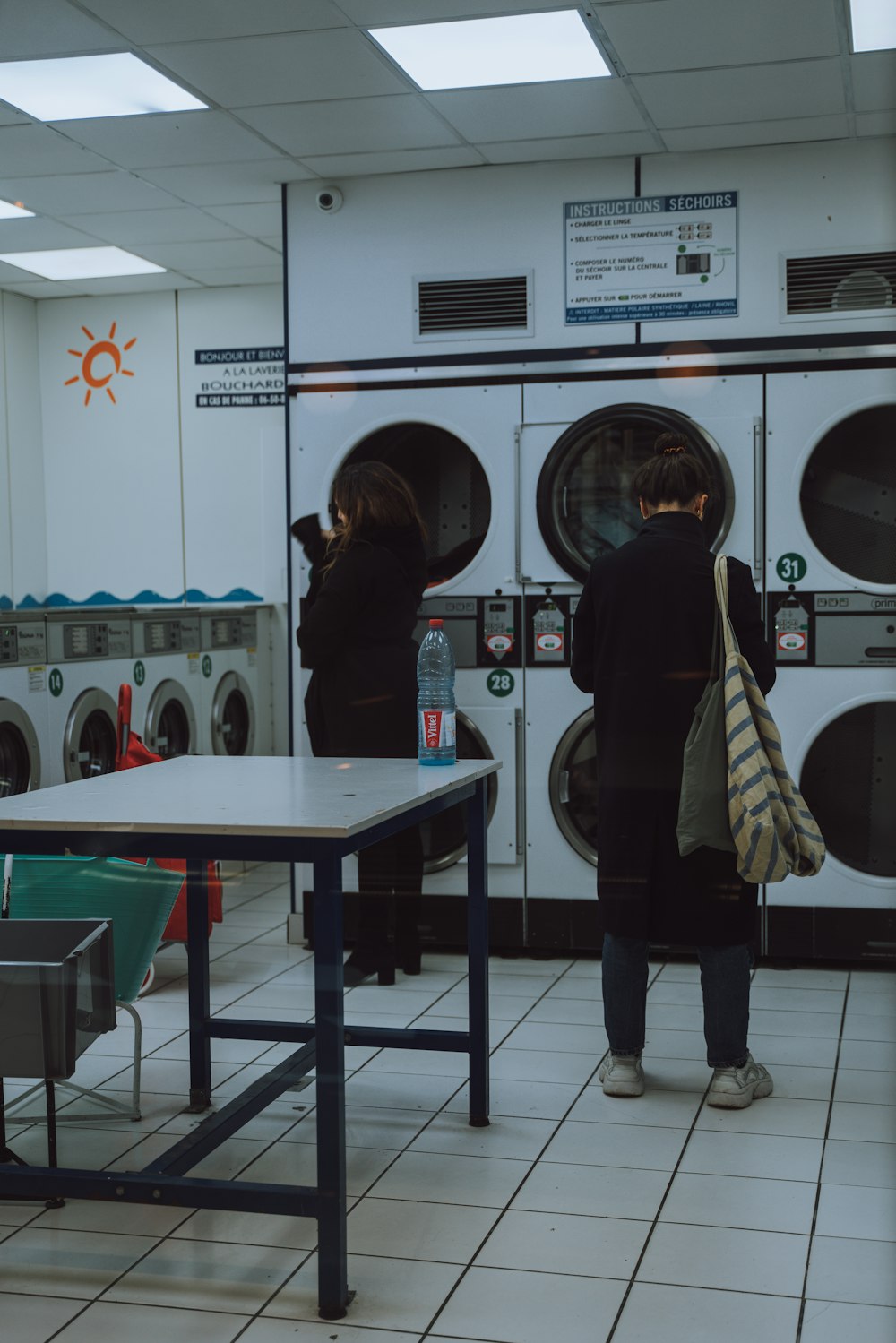 woman standing in front of the front load washer