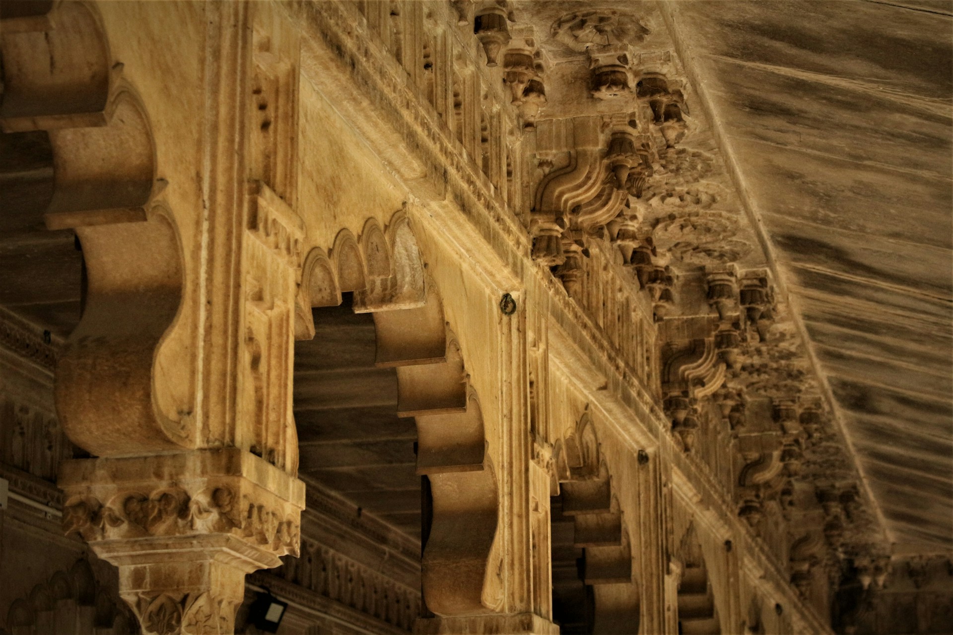 woman wearing yellow long-sleeved dress under white clouds and blue sky during daytime