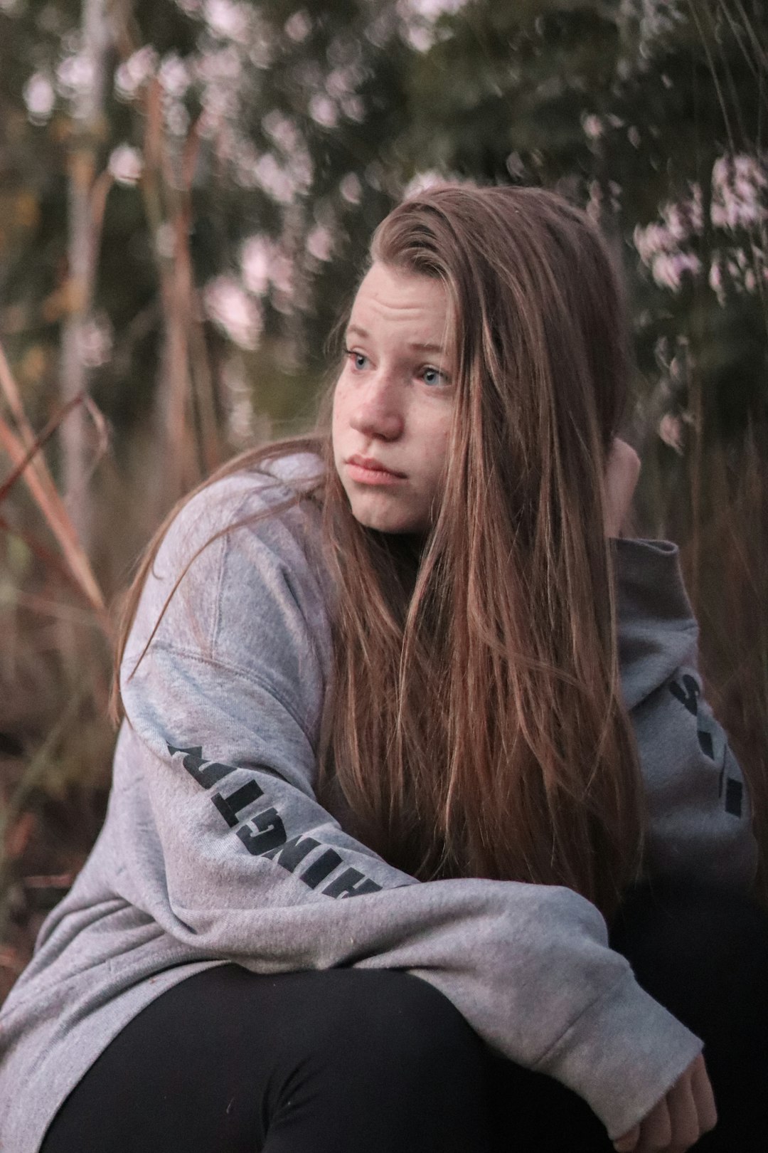 woman wearing grey crew-neck sweater