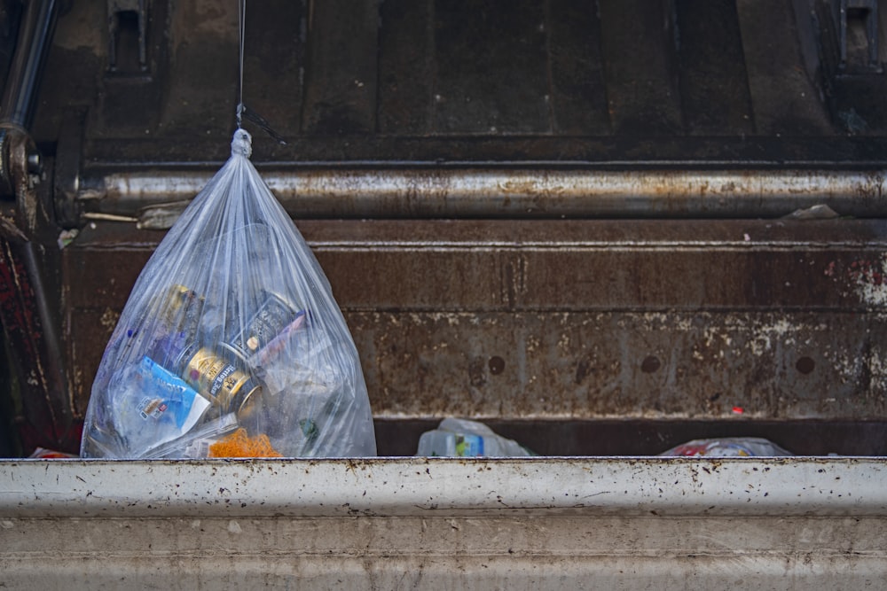 bag of waste in dumpster