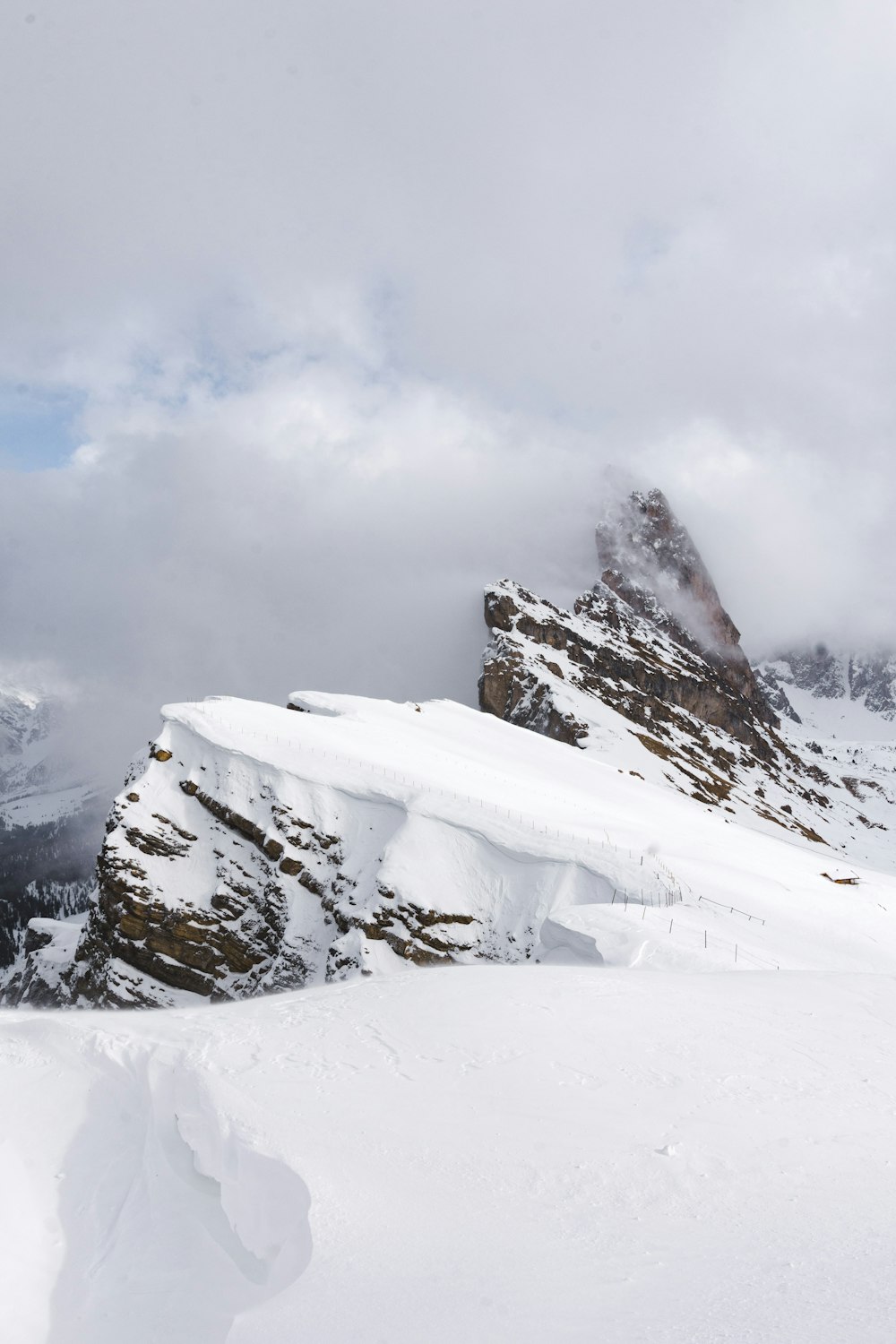 snow-covered mountains under cloudy sky