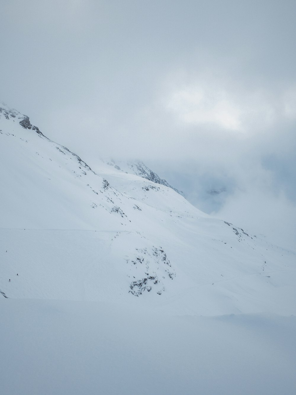 snow-covered mountains under heavy clouds