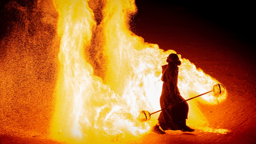 man walking near the fire