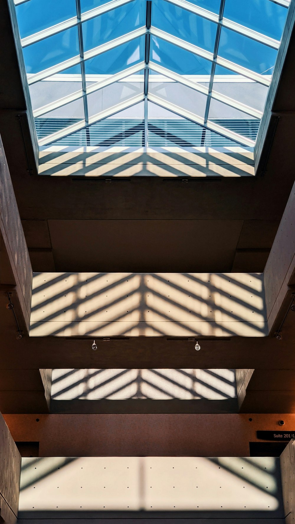 a view of the ceiling of a building with a skylight