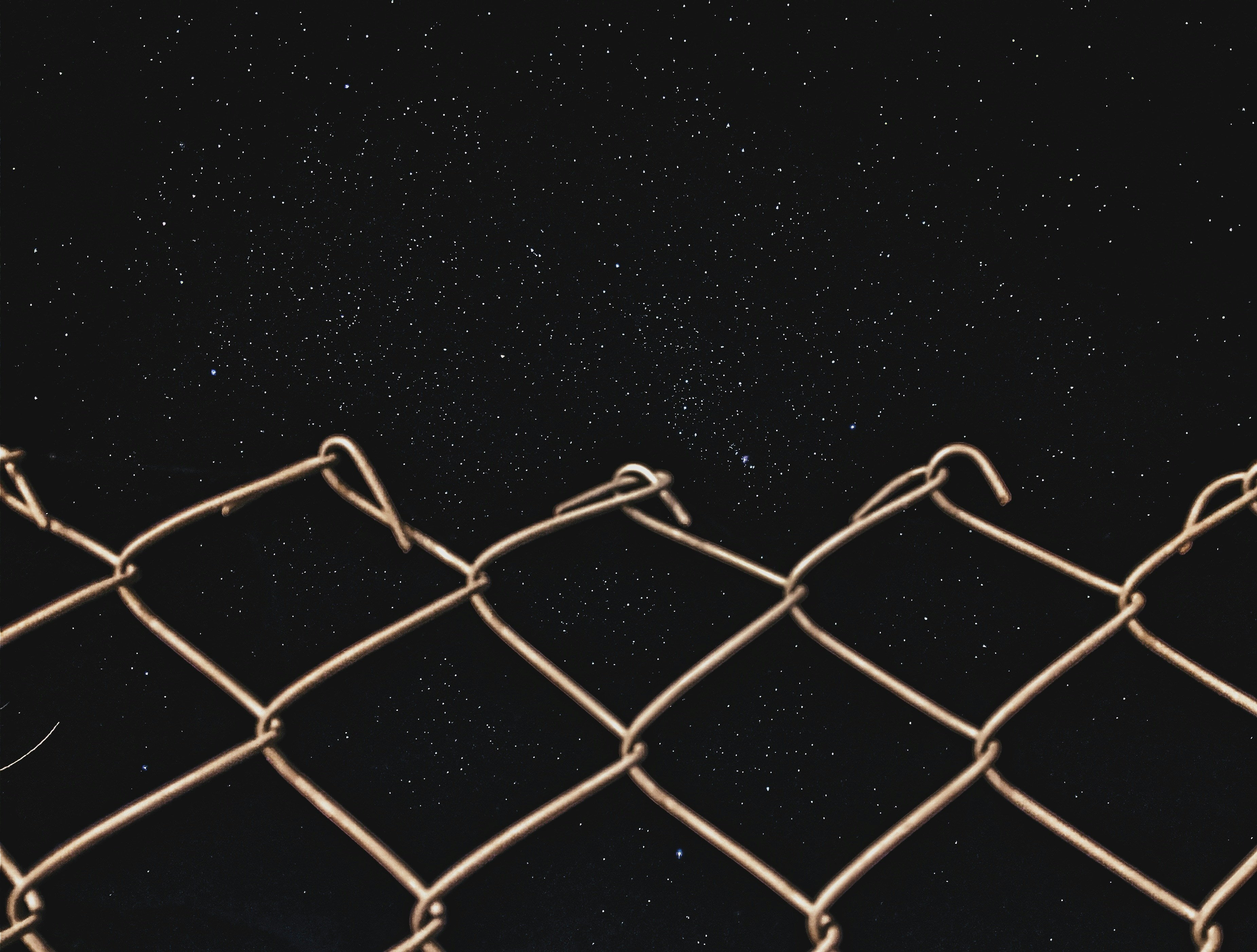 gray chain link fence at night