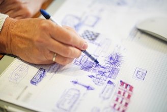 selective focus photography of person sketching