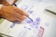 selective focus photography of person sketching