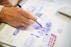 selective focus photography of person sketching
