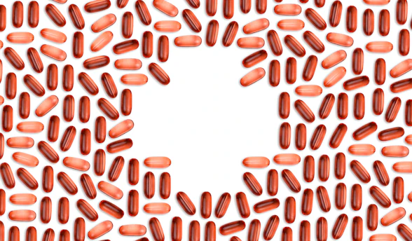 Close-up of a healthy heart illustration with omega-3 capsules around it.