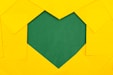 yellow papers forming green heart hole