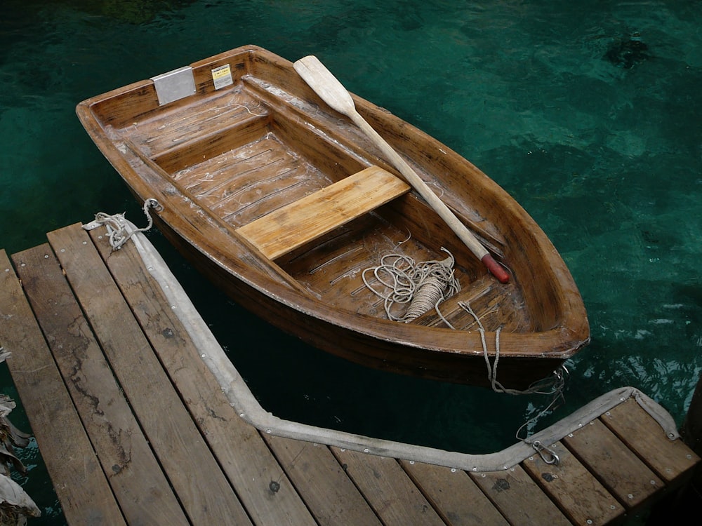 brown wooden boat with paddle