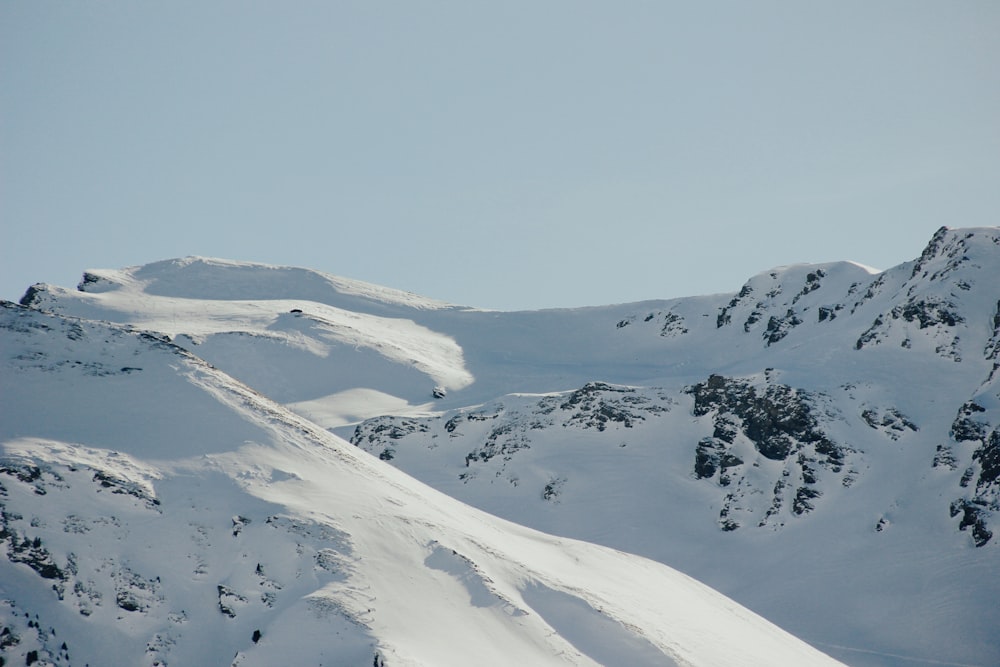 snow-covered mountains under white sky