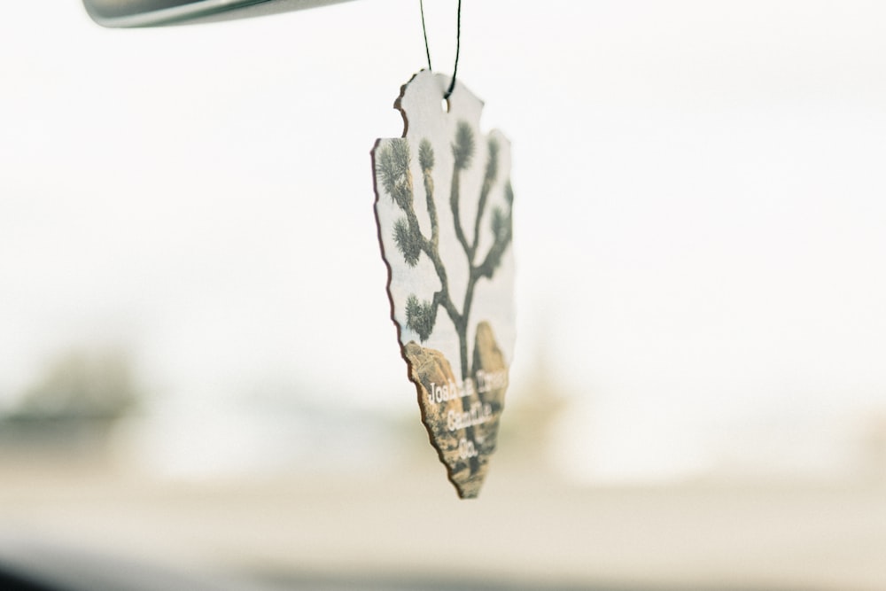 a wind chime hanging from the side of a car