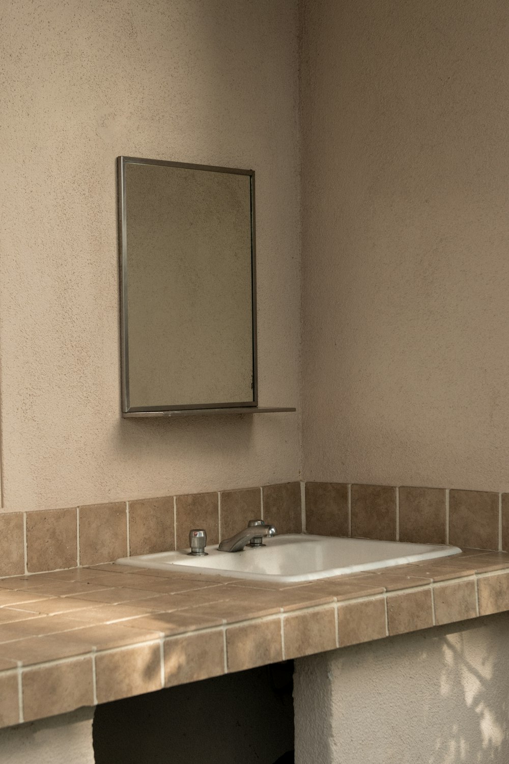 white and brown vanity sink with mirror