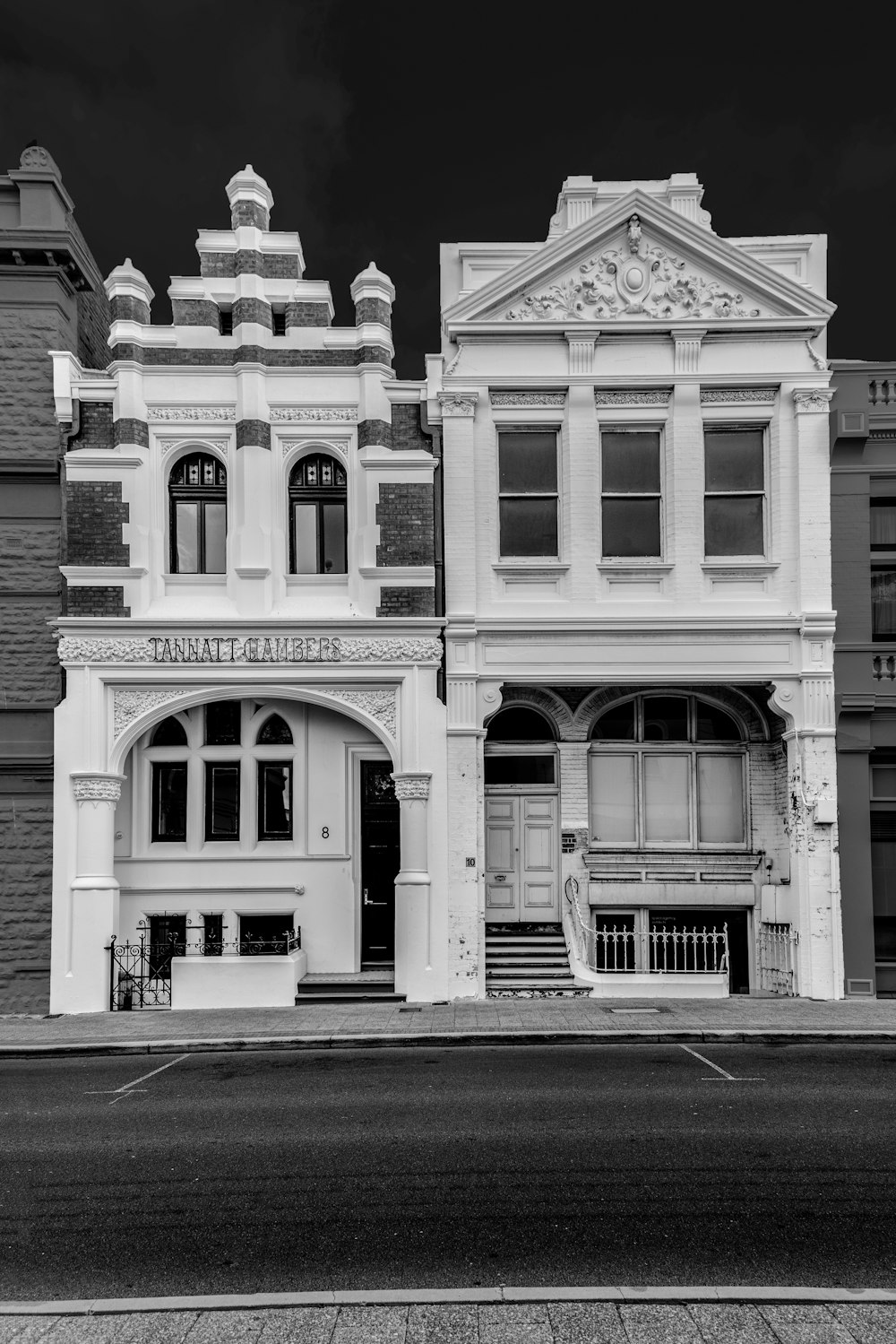 grayscale photo of 2-story buildings