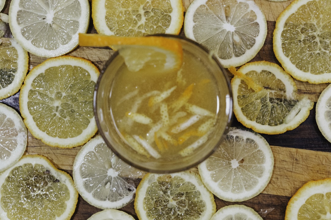 full drinking glass surrounded with lemon slices, This is my first attempt at making a cocktail with my first bottle of 