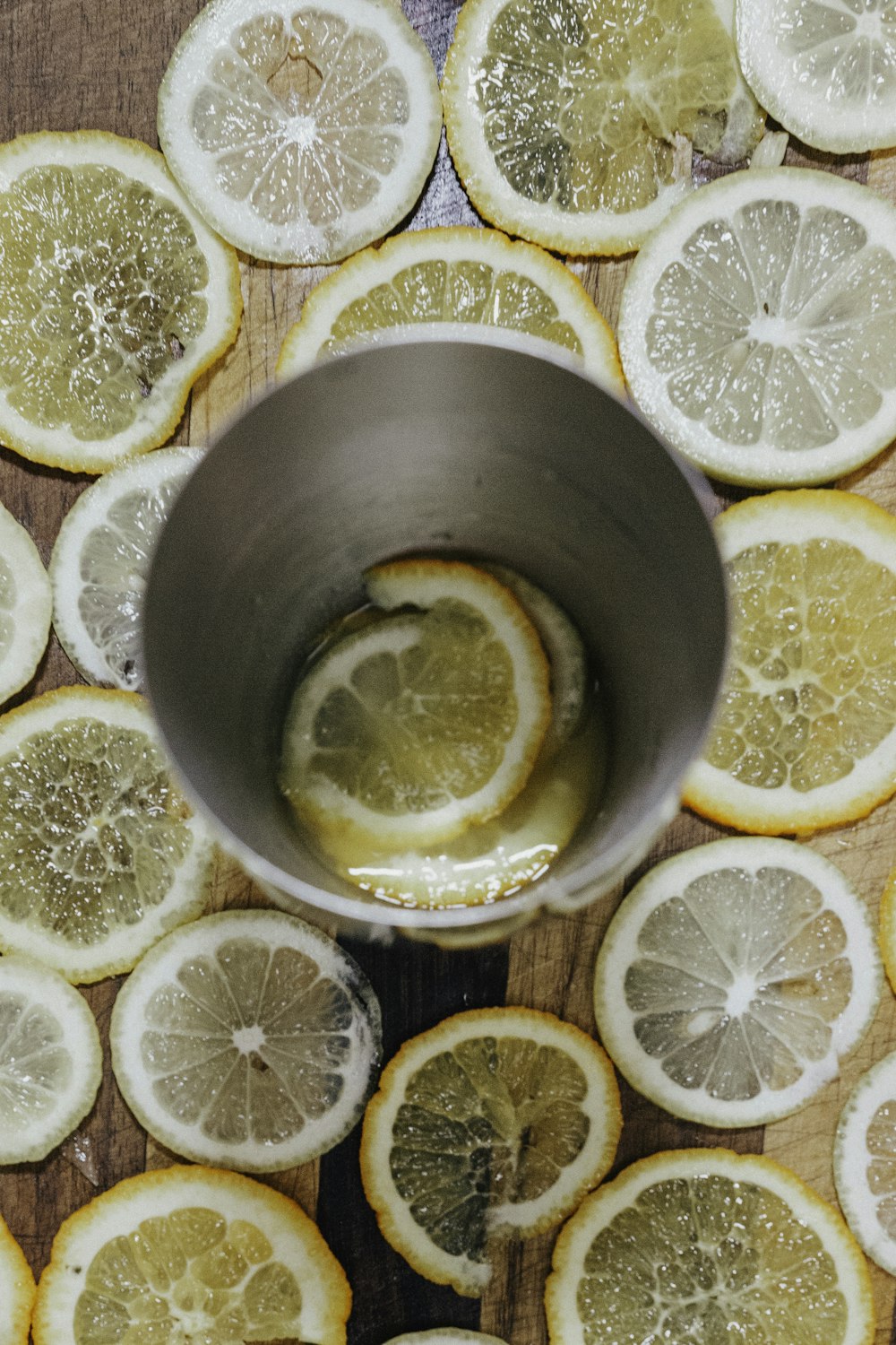 metal drinking cup surrounded with lemon slices