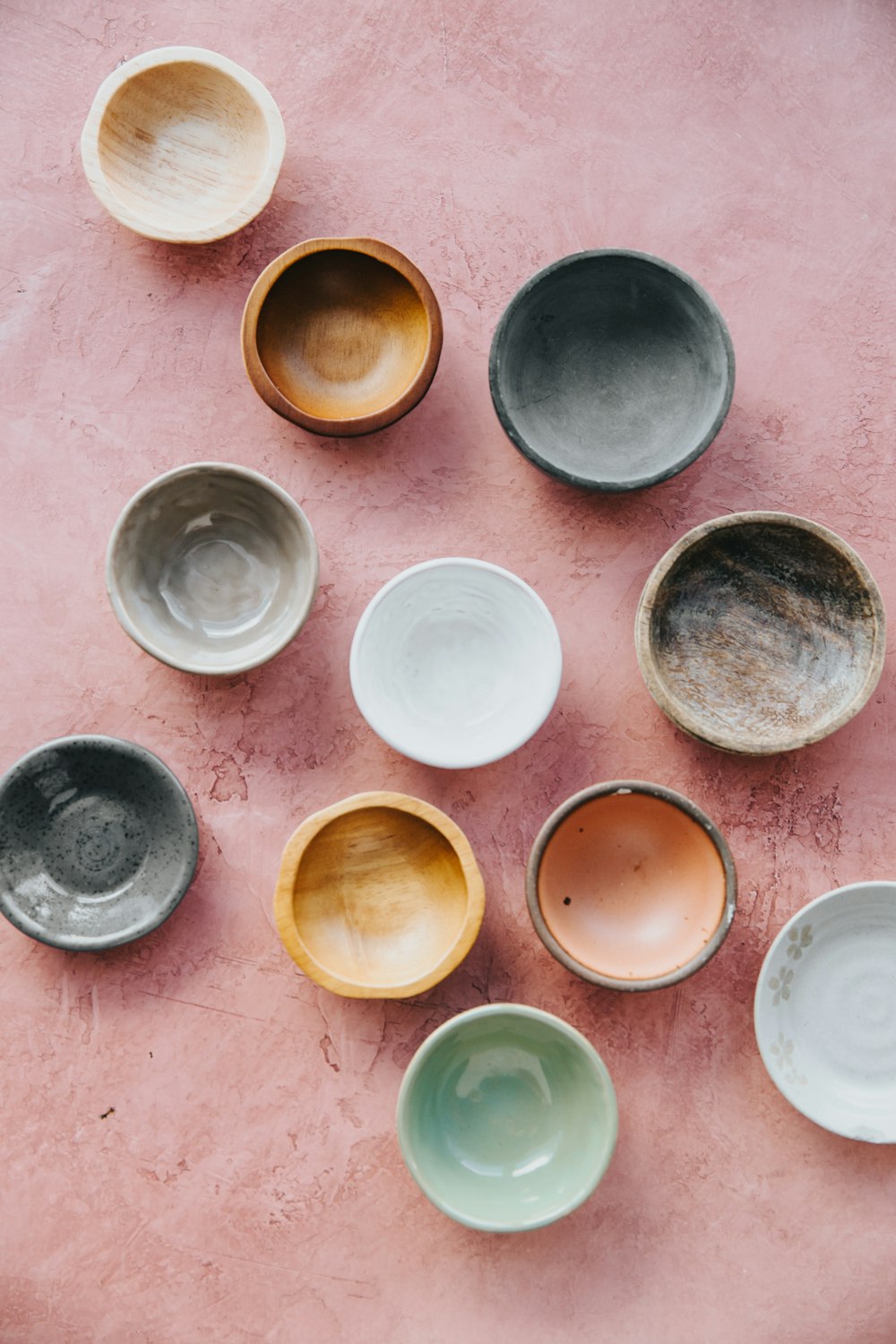 assorted bowls on brown surface